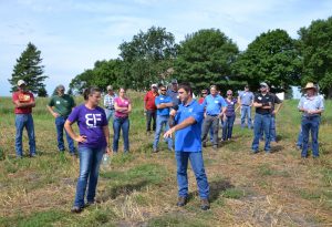 Showing guests a field that had cereal rye growing, which they baled earlier in the year