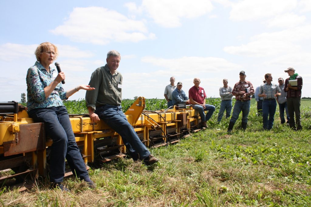 Margaret Smith and Doug Alert, of Ash Grove Farm, discuss organic crop production and cover crops at a field day they hosted.