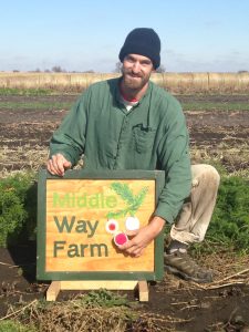 Jordan Scheibel posing with his Middle Way Farm sign submitted by him
