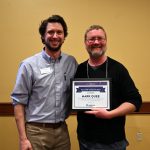 Newly minted master researcher Mark Quee poses with his Master Researcher Award and Stefan Gailans
