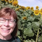 Ann Franzenburg by sunflowers