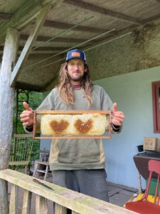 Ben Hoksch with honey from his hives