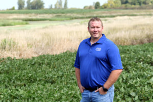 Bill Gordon posing on his Worthington, MN farm