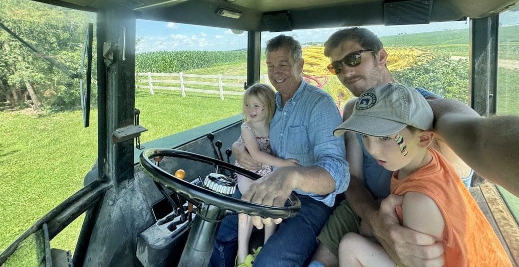 Chris and his kids help Jim with some farm work. Photo courtesy of Chris Pelzer