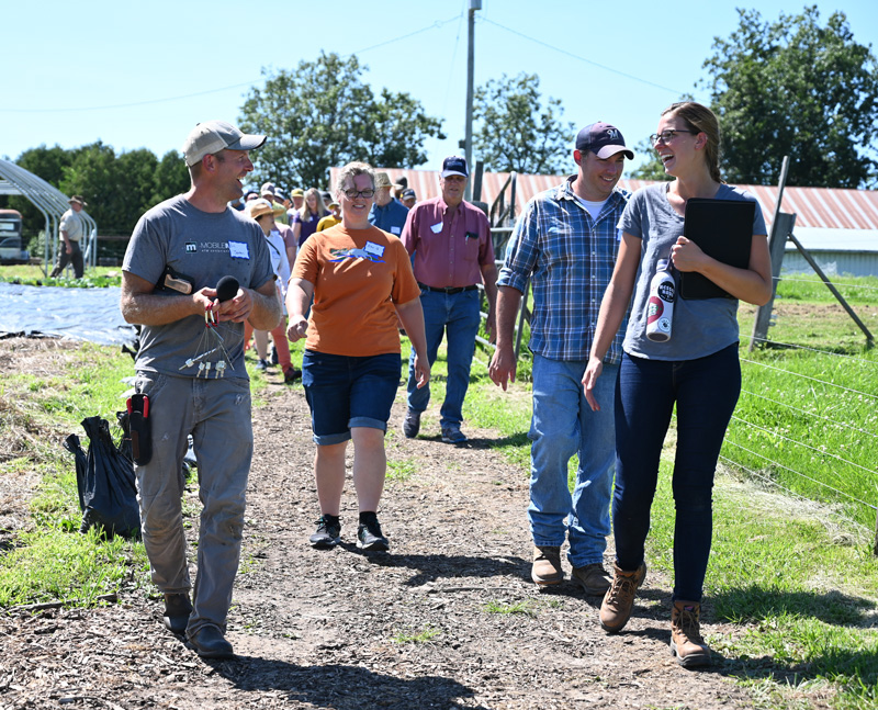 Field day attendees chatting while walking to next destination