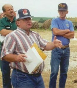 Vic Madsen, speaking, discusses on farm research at a PFI field day in the early 1990s