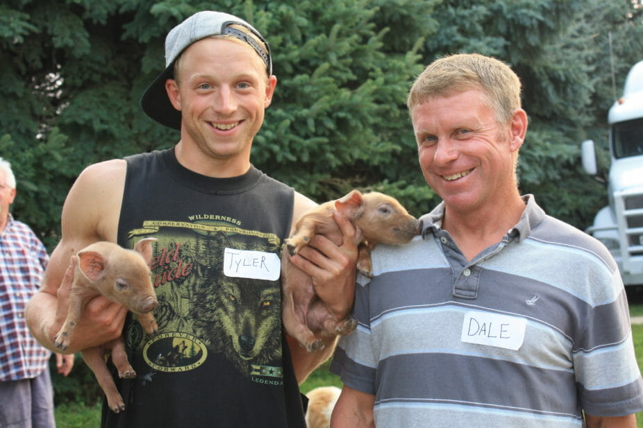 Tyler and Dale with red wattle piglets. 