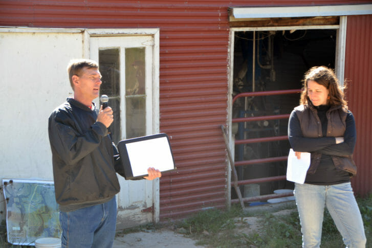 Joe Schultz and Kayla Koether present in front of parlor