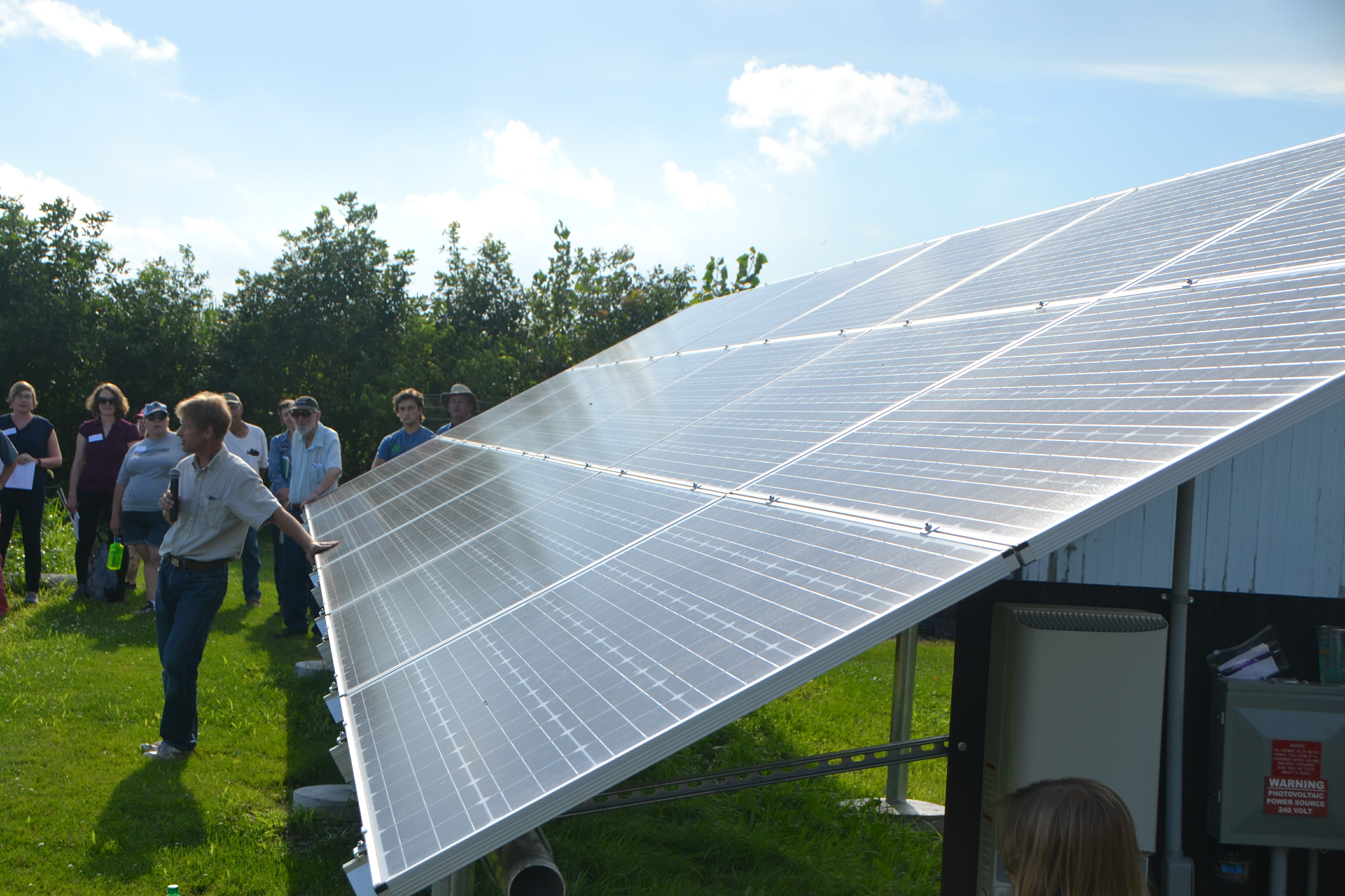 Todd Hammen, of Iowa Energy Alternatives, with one of Lees photovoltaic solar arrays.
