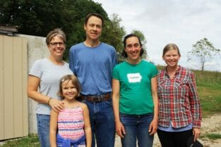 Sara Peterson, Erik Sessions and one of their daughters, Nina, pose with both Emily's for a photo.