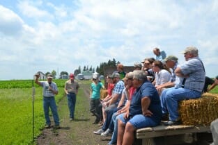 Craig shows the crowd his small, cattail wetland and wet prairie.
