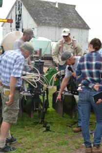 Craig explains a cultivator to several PFI members.